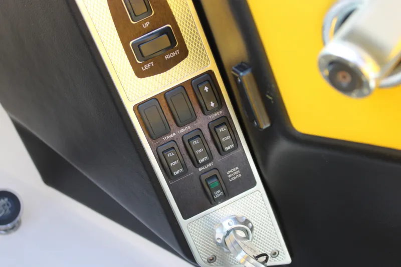 Slide: The Image of Control panel of a 2013 MasterCraft X-2 boat with various switches and buttons. - 37