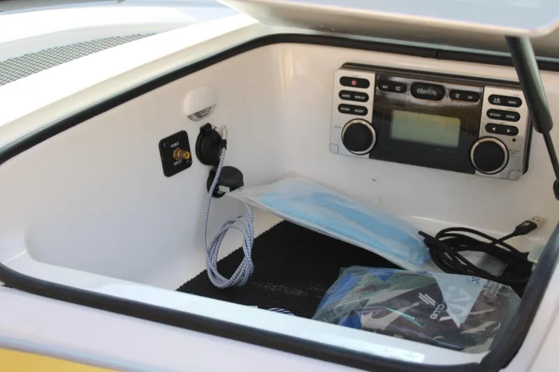 Slide: The Image of 2013 MasterCraft X-2 boat storage compartment with Clarion stereo system and accessories. - 38