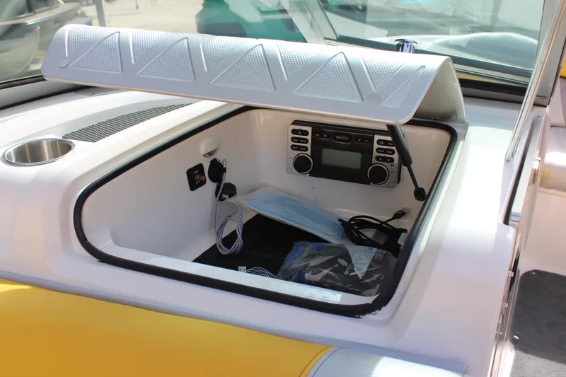 Slide: The Image of 2013 MasterCraft X-2 boat dashboard with open storage compartment and audio system. - 39