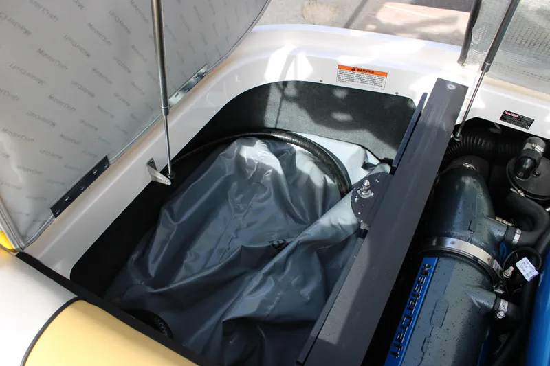 Slide: The Image of 2013 MasterCraft X-2 boat engine compartment with open hatch and visible components. - 42