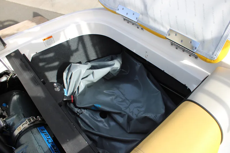 Slide: The Image of 2013 MasterCraft X-2 boat storage compartment with engine and folded cover. - 43