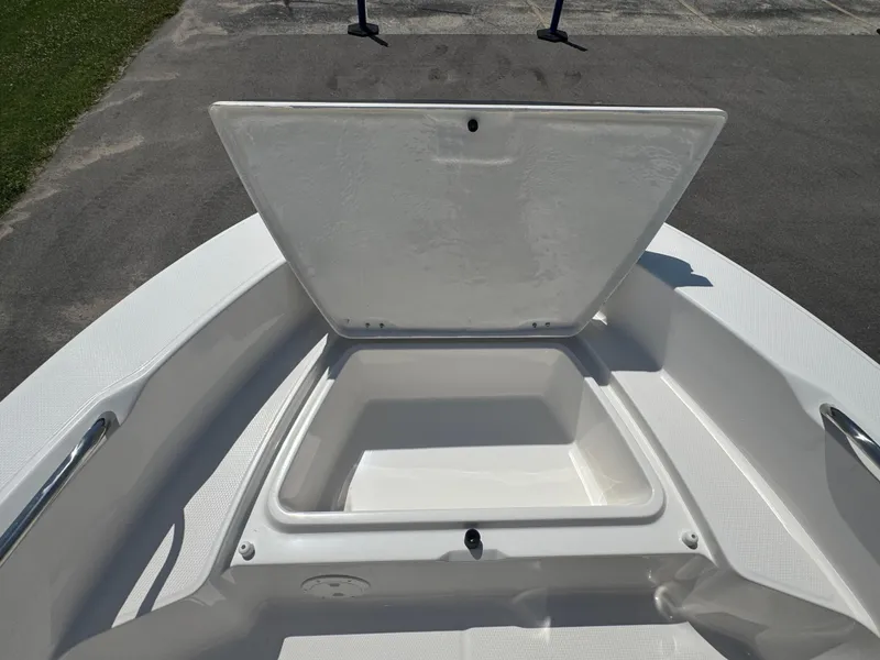 Slide: The Image of 2025 Robalo R160 Center Console boat with open storage compartment on deck. - 10