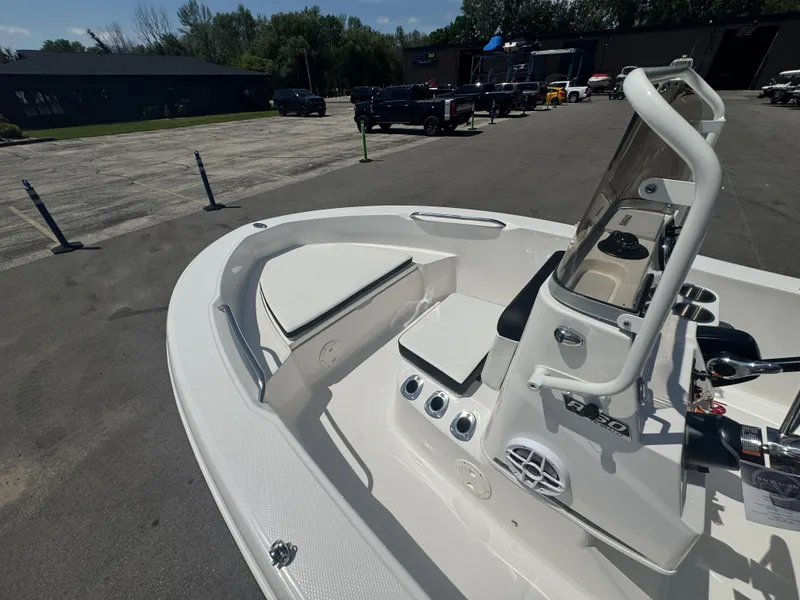 Slide: The Image of 2025 Robalo R160 Center Console boat in a parking lot, showcasing sleek design and features. - 13