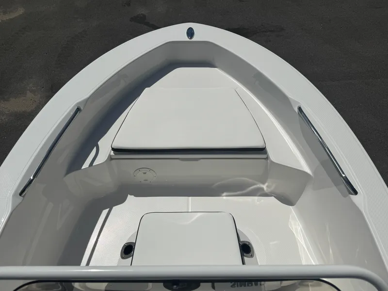 Slide: The Image of 2025 Robalo R160 Center Console boat interior, featuring sleek white seating and storage compartments. - 16