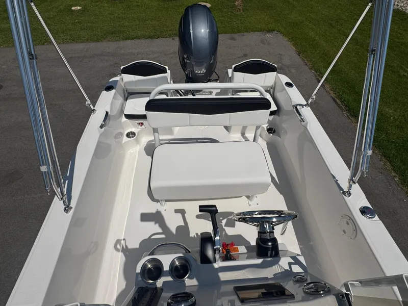 Slide: The Image of 2025 Robalo R160 Center Console boat interior with steering wheel and seating. - 17