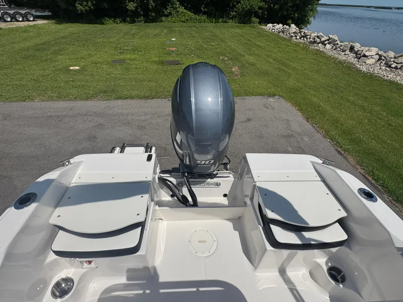 Slide: The Image of 2025 Robalo R160 Center Console boat with Yamaha engine, parked near a lake. - 19