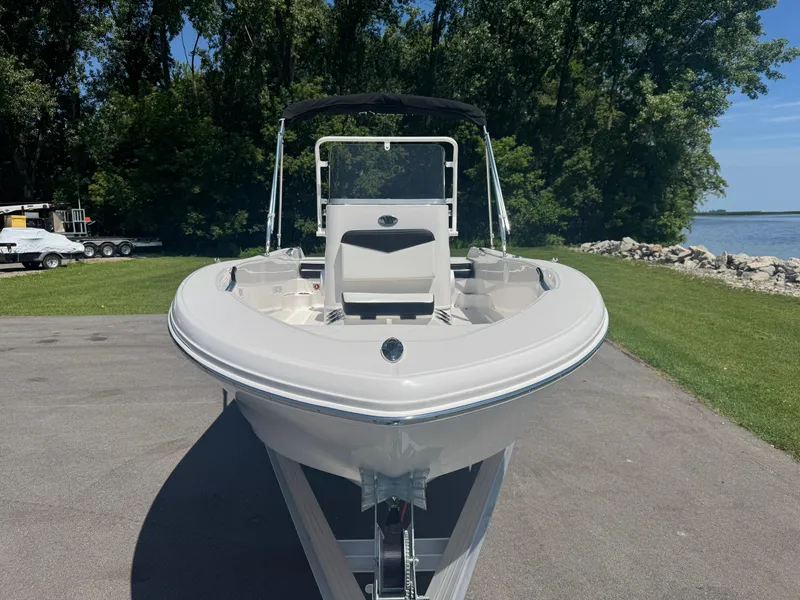 Slide: The Image of 2025 Robalo R160 Center Console boat on trailer by lakeside. - 2