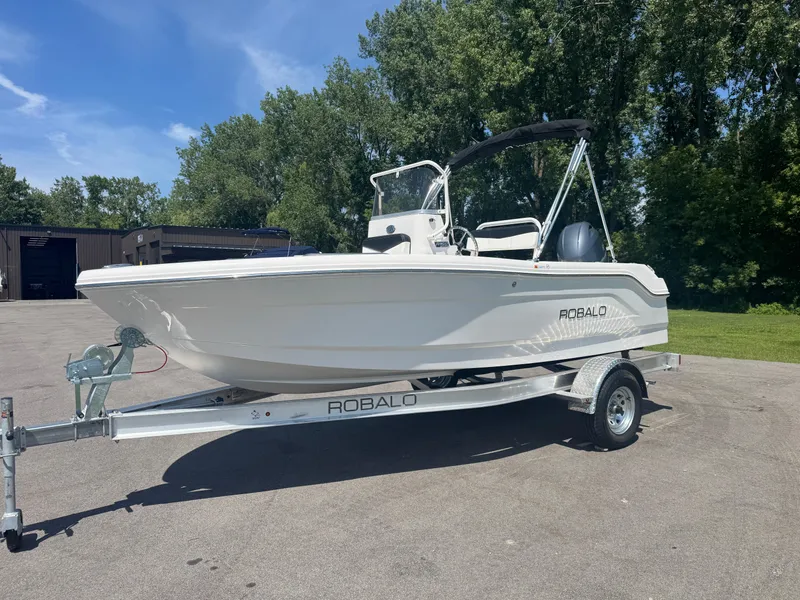 Slide: The Image of 2025 Robalo R160 Center Console boat on trailer, parked outdoors. - 3