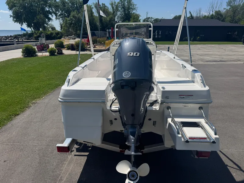 Slide: The Image of 2025 Robalo R160 Center Console boat with Yamaha 90 engine, parked outdoors. - 7