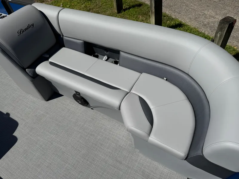 Slide: The Image of 2026 Bentley Pontoons Legacy 243 Swingback Dual Capt. seating, featuring sleek gray upholstery. - 11