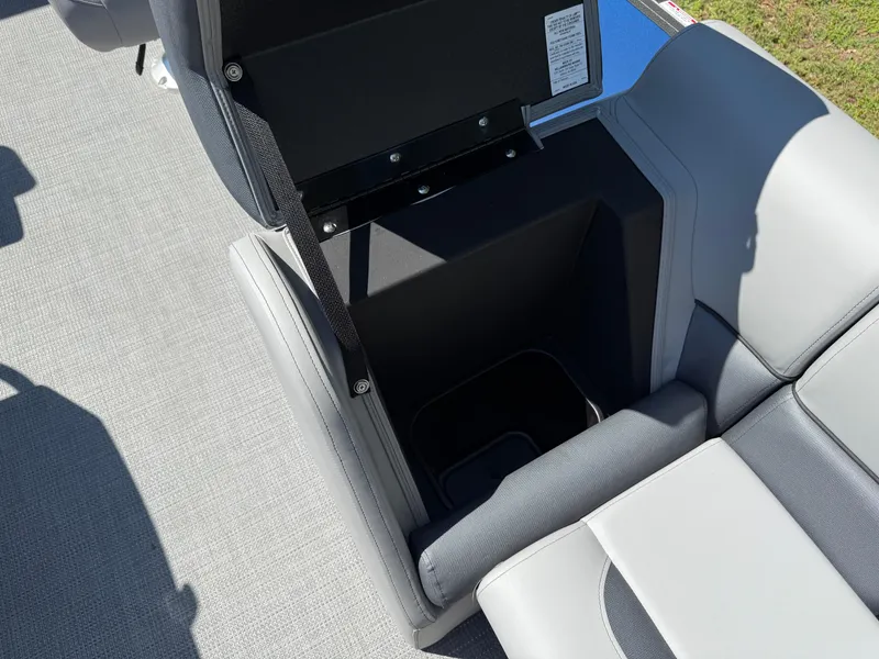 Slide: The Image of 2026 Bentley Pontoons Legacy 243 Swingback seat storage compartment, open, showing interior space. - 13