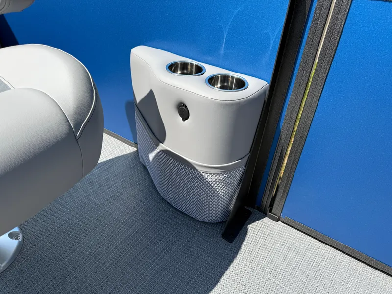 Slide: The Image of 2026 Bentley Pontoons Legacy 243 interior with dual cup holders and blue paneling. - 16