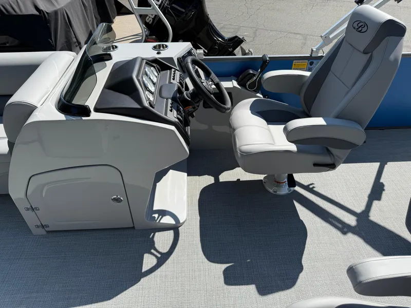 Slide: The Image of 2026 Bentley Pontoons Legacy 243 Swingback Dual Capt. helm with luxurious captain's chair and controls. - 18