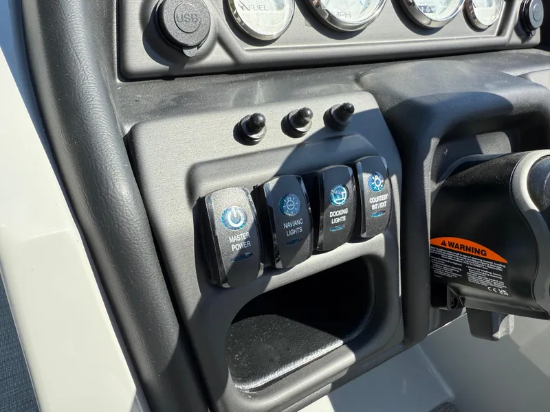 Slide: The Image of Control panel of 2026 Bentley Pontoons Legacy 243 with switches and gauges. - 23