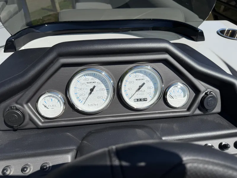 Slide: The Image of Dashboard of 2026 Bentley Pontoons Legacy 243, featuring Suzuki gauges for fuel, speed, RPM, and volts. - 24