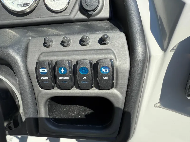 Slide: The Image of Control panel of 2026 Bentley Pontoons Legacy 243 with stereo, electronics, accessories, and horn switches. - 25