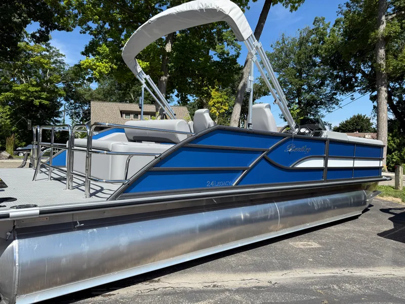 Slide: The Image of 2026 Bentley Pontoons Legacy 243 Swingback Dual Capt. in blue, parked outdoors. - 8
