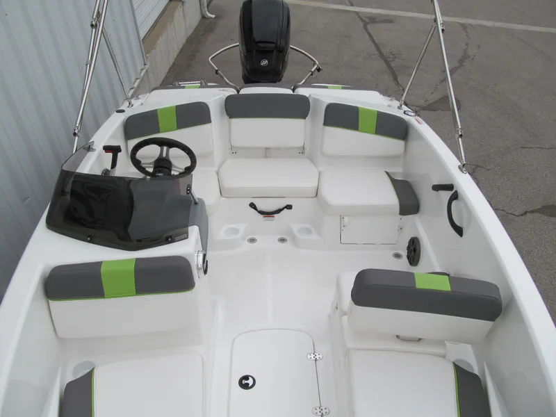 Slide: The Image of 2023 Tahoe T16 boat interior with gray and green seating, steering wheel, and console. - 10