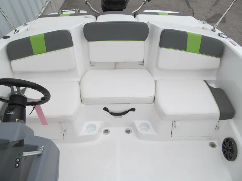 Slide: The Image of 2023 Tahoe T16 boat interior with white and green seating, steering wheel, and storage compartments. - 11