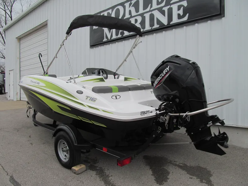 Slide: The Image of 2023 Tahoe T16 boat with Mercury engine, parked outside a marine shop. - 3