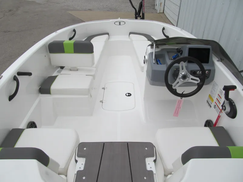 Slide: The Image of 2023 Tahoe T16 boat interior with steering wheel, seating, and dashboard controls. - 5