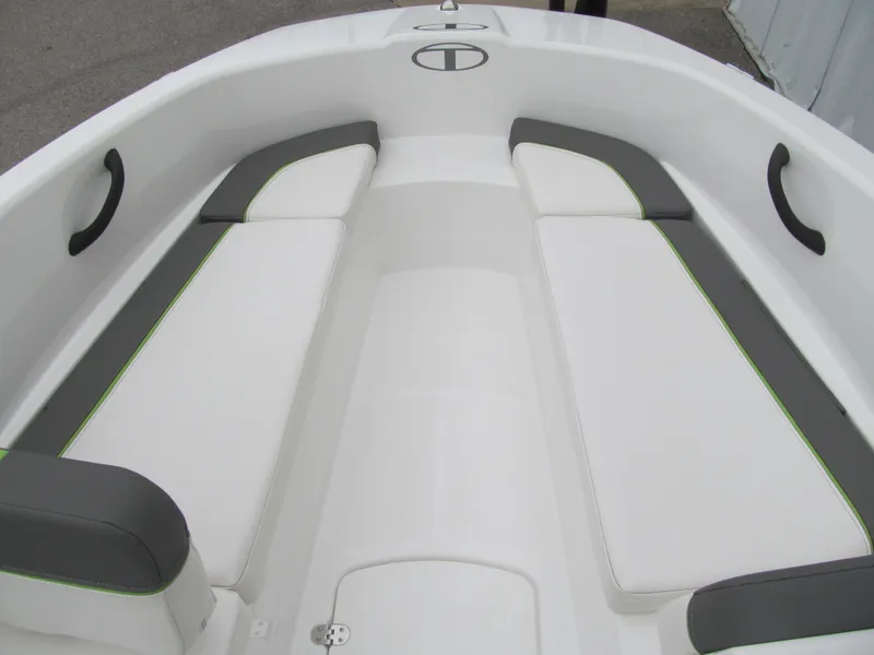 Slide: The Image of 2023 Tahoe T16 boat interior with white and gray seating, green accents, and black handles. - 8
