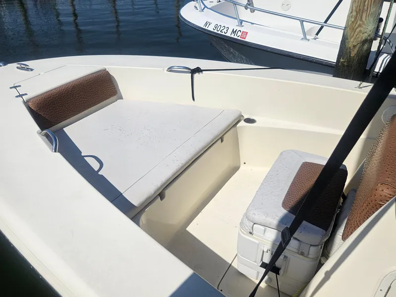 Slide: The Image of 2013 Scout 195 Sportfish boat interior with cushioned seating and cooler. - 3