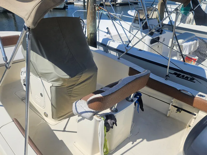 Slide: The Image of 2013 Scout 195 Sportfish boat interior with covered console and seating at marina. - 4