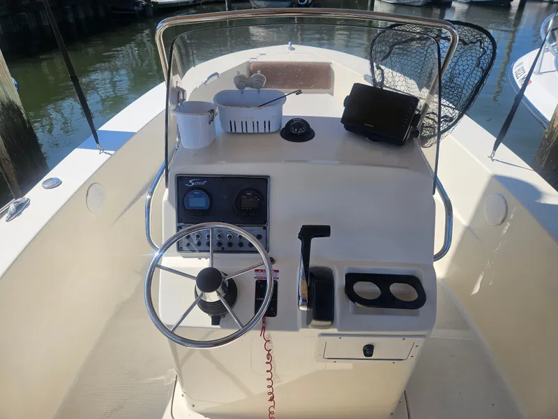 Slide: The Image of 2013 Scout 195 Sportfish boat dashboard with steering wheel and controls. - 5