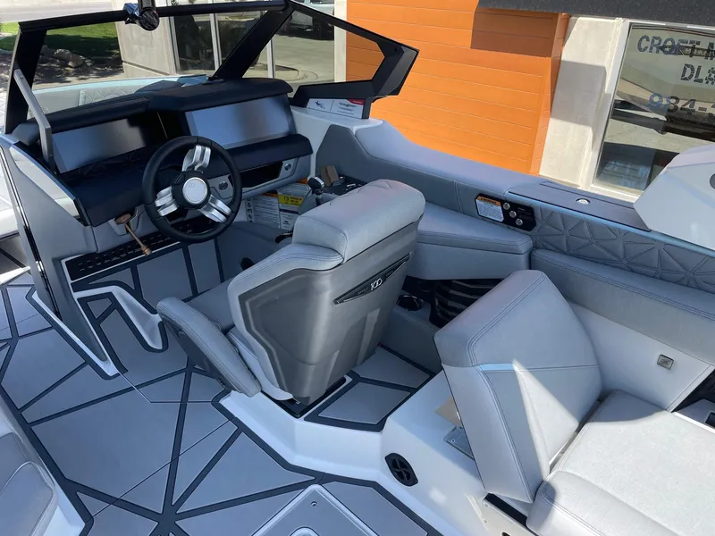 Slide: The Image of Interior of 2025 Nautique Super Air Nautique G25 Paragon boat, featuring modern seating and dashboard. - 6