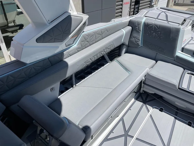 Slide: The Image of 2025 Nautique Super Air Nautique G25 Paragon interior with luxurious gray seating and cup holders. - 7