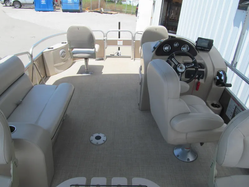 Slide: The Image of Interior of a 2018 Berkshire 17A CTS pontoon boat with beige seating and steering console. - 5