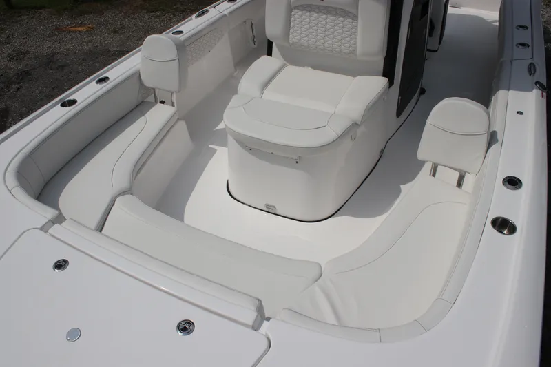 Slide: The Image of 2026 Tidewater 2700 Carolina Bay boat interior with white seating and modern design. - 12