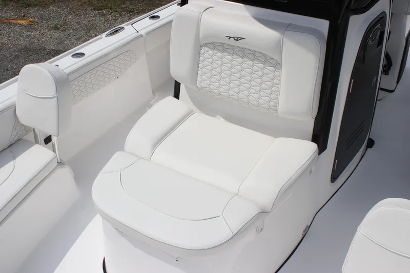 Slide: The Image of 2026 Tidewater 2700 Carolina Bay boat interior with white cushioned seating. - 14