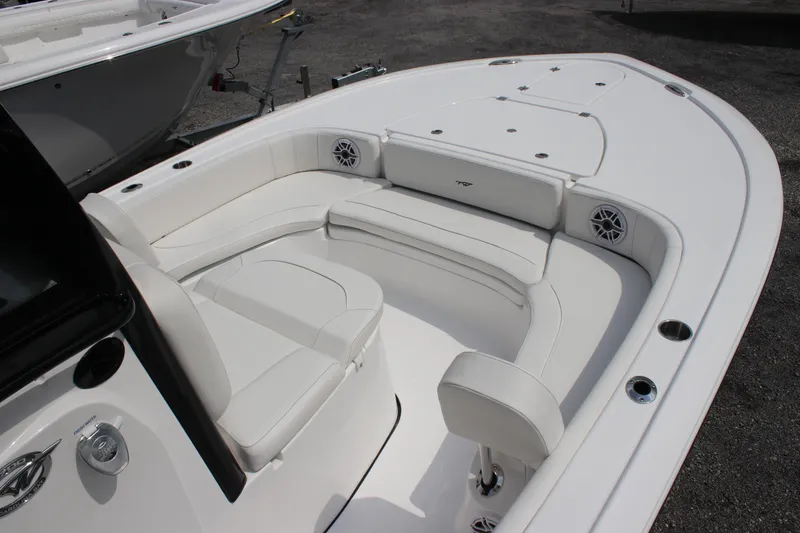 Slide: The Image of 2026 Tidewater 2700 Carolina Bay boat interior with white seating and speakers. - 16