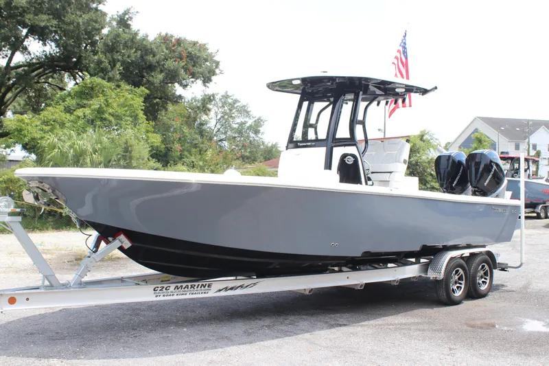 Slide: The Image of 2026 Tidewater 2700 Carolina Bay boat on trailer, parked outdoors. - 2