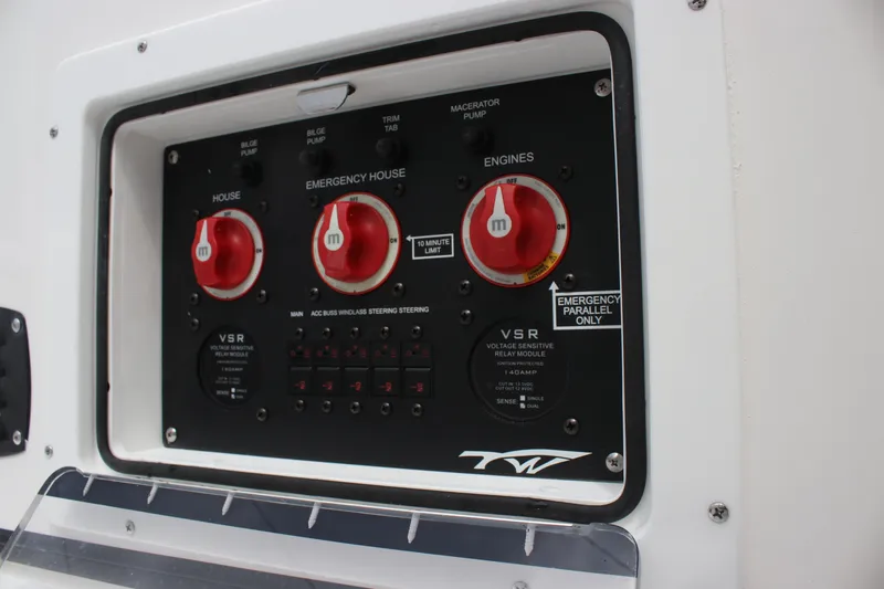 Slide: The Image of Control panel of 2026 Tidewater 2700 Carolina Bay boat with switches and dials. - 22