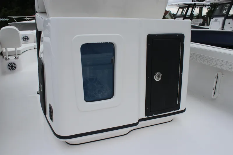 Slide: The Image of 2026 Tidewater 2700 Carolina Bay boat interior, featuring storage compartments and seating area. - 26