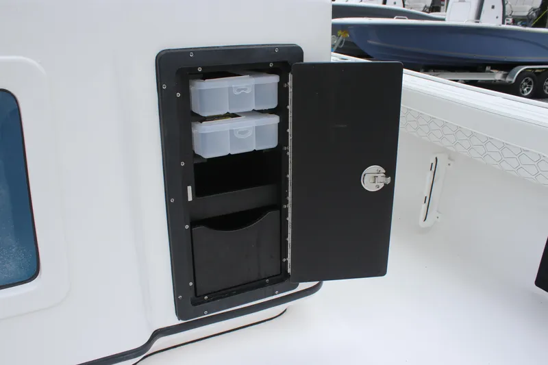 Slide: The Image of Storage compartment on 2026 Tidewater 2700 Carolina Bay boat, featuring organized tackle boxes. - 27
