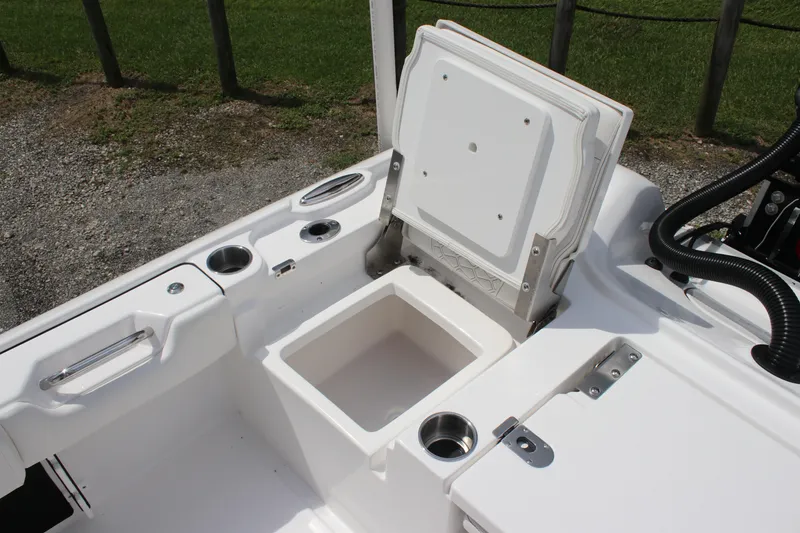 Slide: The Image of 2026 Tidewater 2700 Carolina Bay boat with open storage compartment and cup holders. - 31