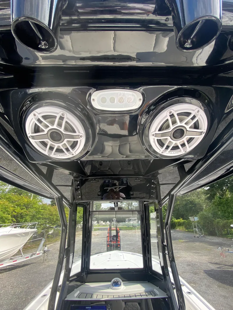 Slide: The Image of 2026 Tidewater 2700 Carolina Bay boat with speakers and sleek black interior design. - 8