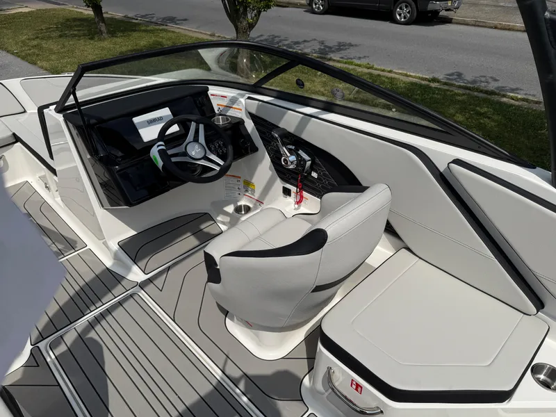 Slide: The Image of 2026 Sea Ray SPX 210 Outboard boat interior with modern steering and seating. - 10