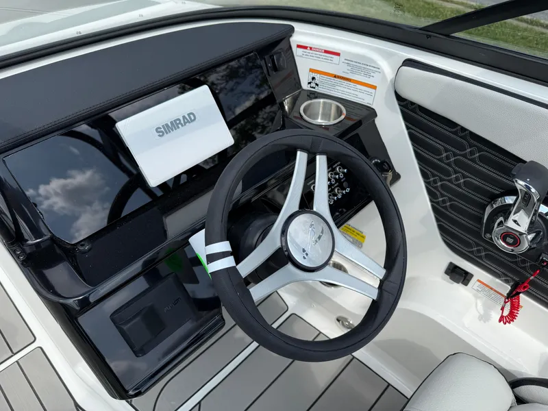 Slide: The Image of 2026 Sea Ray SPX 210 Outboard dashboard with steering wheel and Simrad display. - 11