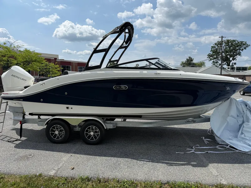 Slide: The Image of 2026 Sea Ray SPX 210 Outboard boat on trailer, parked outdoors under a cloudy sky. - 3