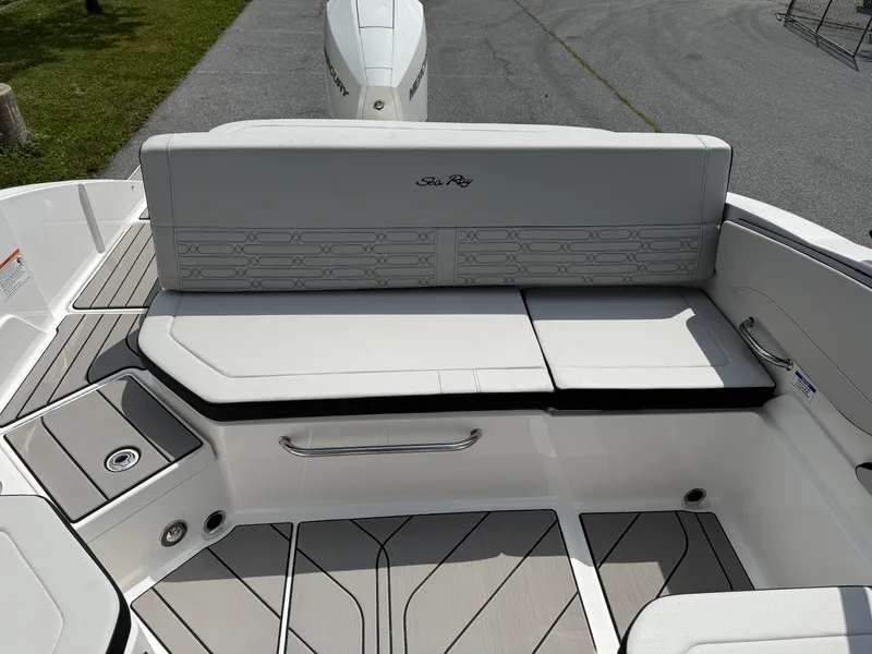 Slide: The Image of 2026 Sea Ray SPX 210 Outboard boat interior with cushioned seating and sleek design. - 6