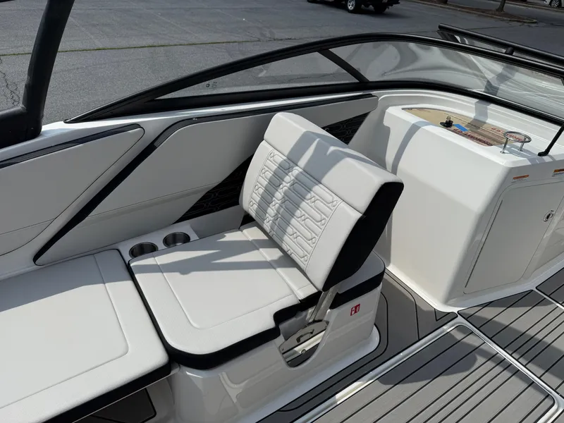 Slide: The Image of 2026 Sea Ray SPX 210 Outboard boat interior with white seating and cup holders. - 9