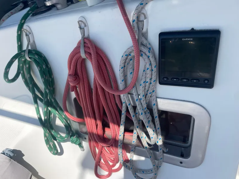 Slide: The Image of Coiled ropes and Garmin device on 1990 Jeanneau Sun Odyssey 36 sailboat deck. - 11