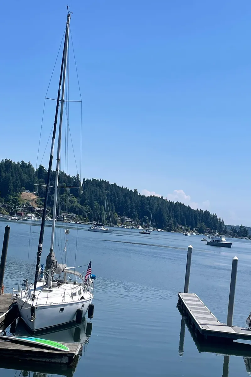 Slide: The Image of Sailboat Jeanneau Sun Odyssey 36 docked in a serene marina, 1990 model. - 13