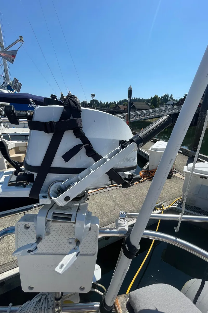Slide: The Image of Outboard motor mounted on a 1990 Jeanneau Sun Odyssey 36 sailboat at a marina. - 15