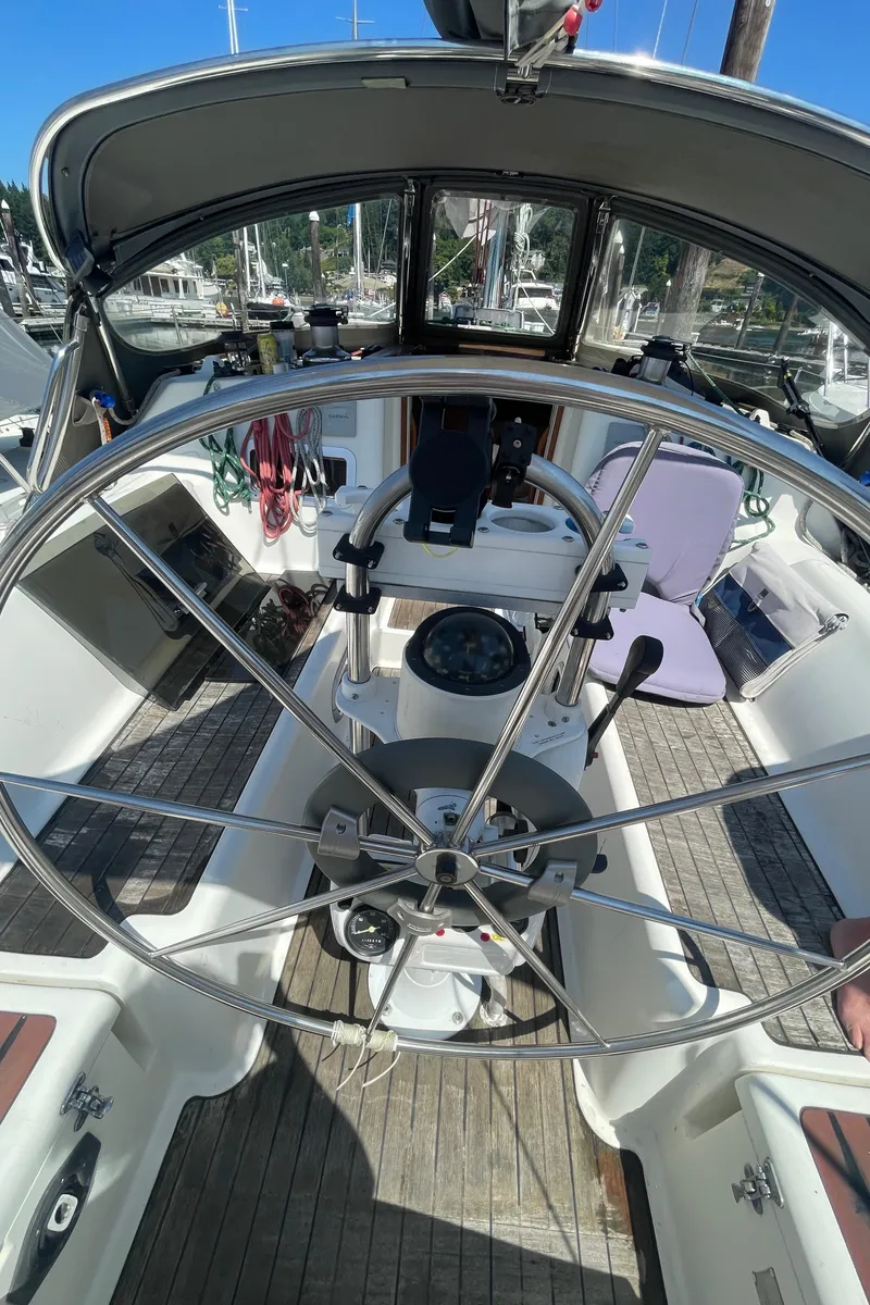 Slide: The Image of Cockpit of 1990 Jeanneau Sun Odyssey 36 sailboat with steering wheel and navigation instruments. - 18